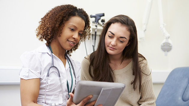 primary care nurse showing patient test results in lynchburg virginia doctors office